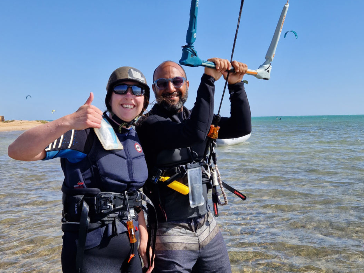 girl doing basic jump with kite using an eleveight kiteboard and wearing a kite tribe lycra